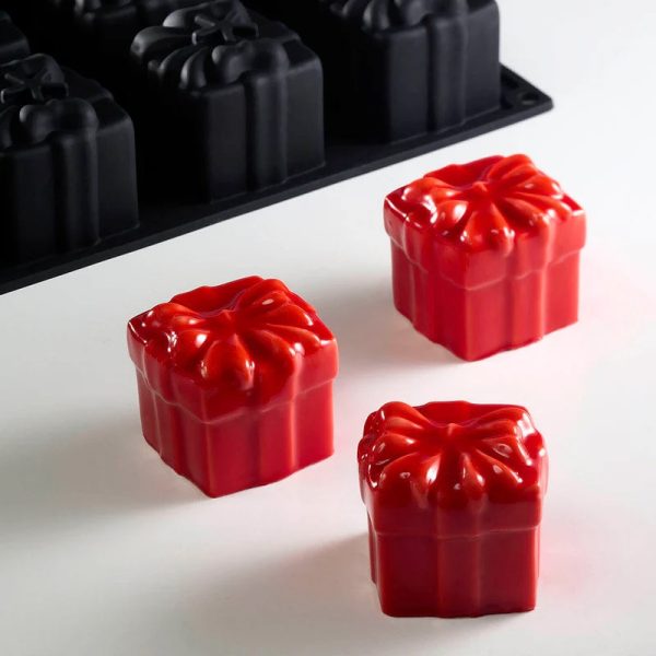 These are red, gift-box-shaped mousse desserts made using a Pavoni Pavoflex PX4395 silicone mold.